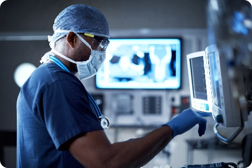 A doctor in scrubs conducting a medical procedure in a hospital.